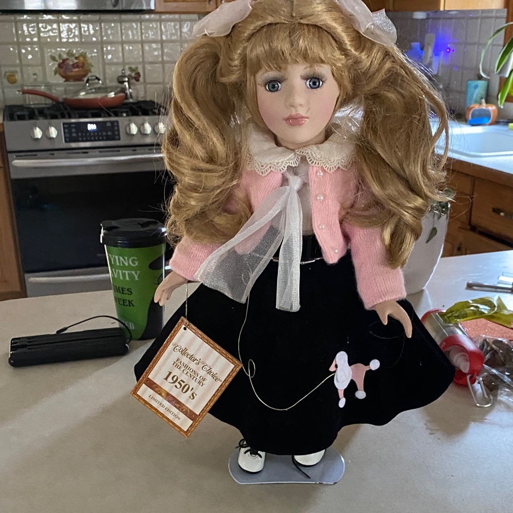 Elegant Porcelain Doll with Pink Cardigan and Black Skirt